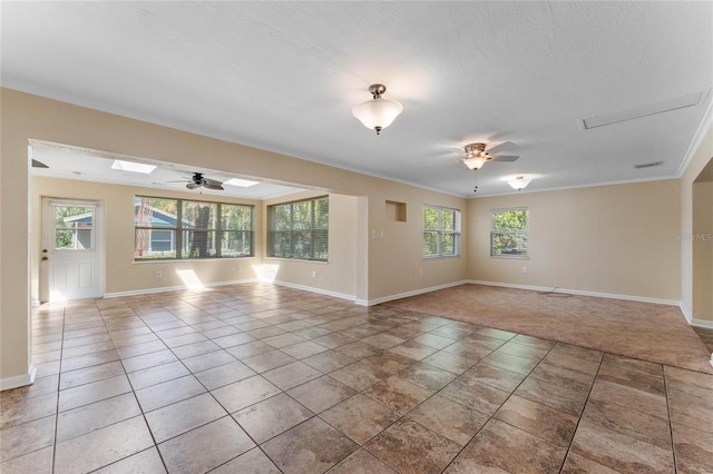 empty room featuring ceiling fan, baseboards, and light tile patterned flooring