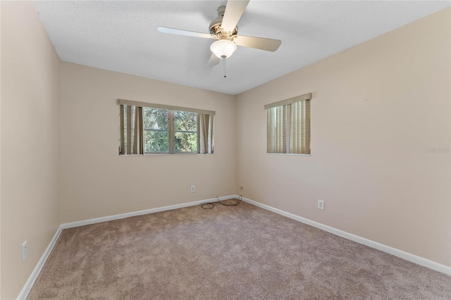 unfurnished room with ceiling fan, baseboards, and carpet