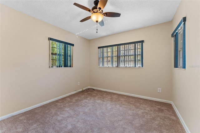 unfurnished room featuring baseboards, a textured ceiling, ceiling fan, and carpet flooring