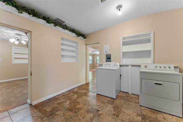 washroom with a ceiling fan, visible vents, washing machine and clothes dryer, laundry area, and a textured ceiling