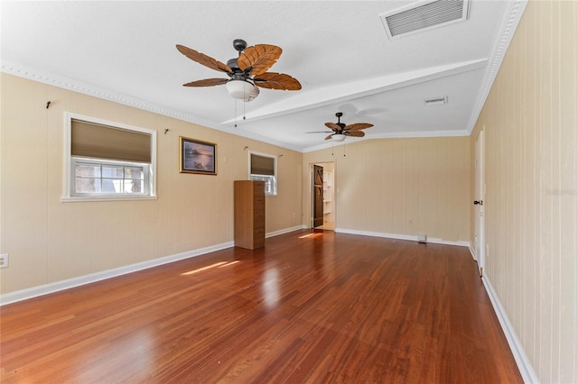 unfurnished room featuring visible vents, beam ceiling, baseboards, and wood finished floors