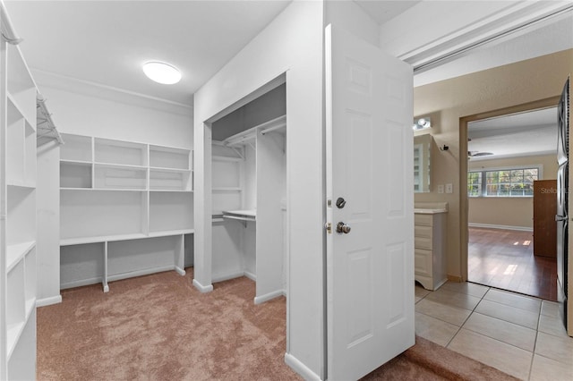 spacious closet featuring tile patterned flooring and carpet floors