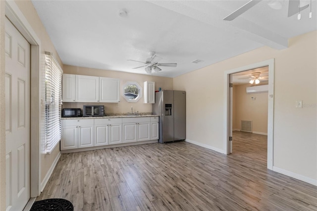 kitchen featuring white cabinetry, visible vents, stainless steel refrigerator with ice dispenser, and ceiling fan