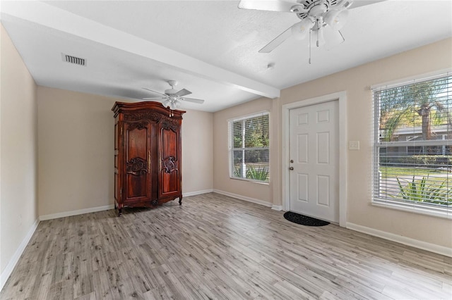 entrance foyer with visible vents, ceiling fan, light wood-type flooring, and baseboards