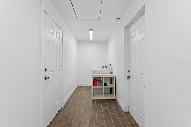 corridor featuring wood finish floors and baseboards