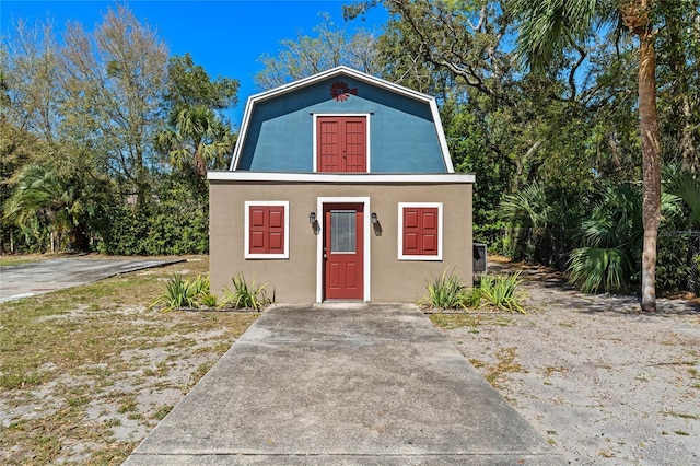 dutch colonial with stucco siding