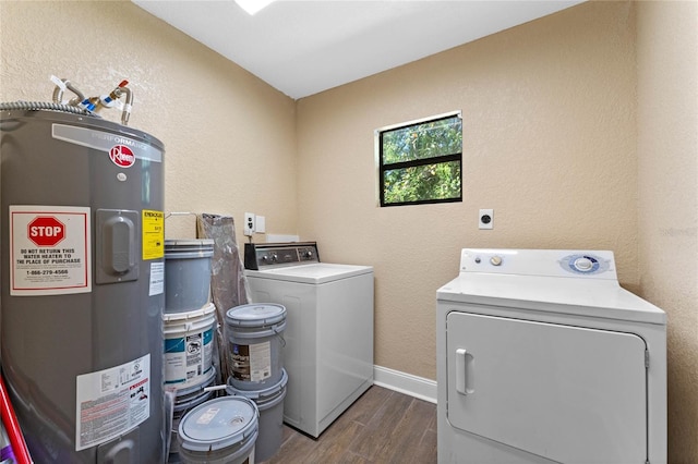 laundry room featuring baseboards, dark wood finished floors, washer and clothes dryer, water heater, and laundry area