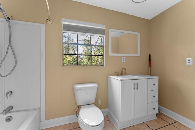 bathroom featuring baseboards, toilet, vanity, tile patterned floors, and washtub / shower combination