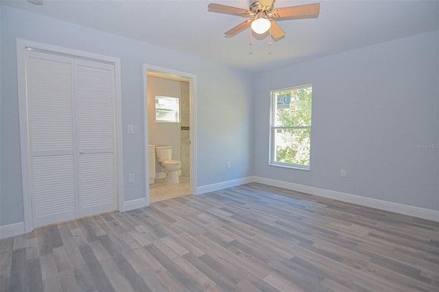 unfurnished room featuring ceiling fan, baseboards, and wood finished floors