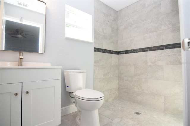 full bathroom featuring visible vents, a ceiling fan, toilet, a tile shower, and vanity