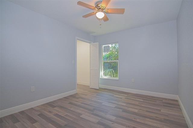 unfurnished room featuring ceiling fan, baseboards, and wood finished floors