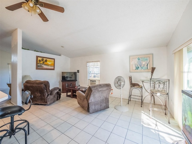 living room featuring vaulted ceiling, light tile patterned floors, plenty of natural light, and a ceiling fan