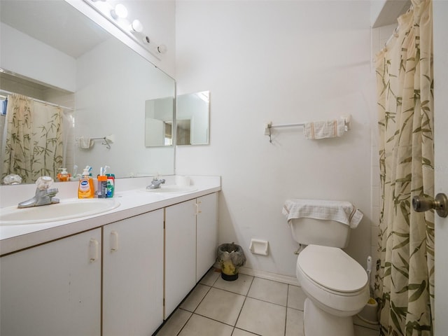 bathroom featuring double vanity, tile patterned flooring, a sink, and toilet