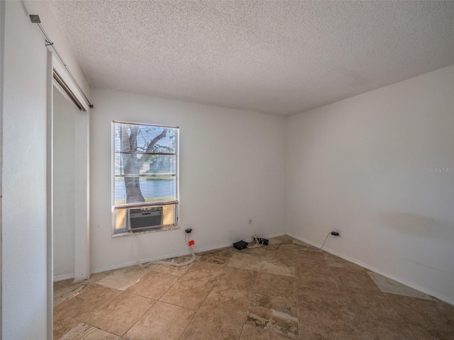 interior space featuring cooling unit and a textured ceiling