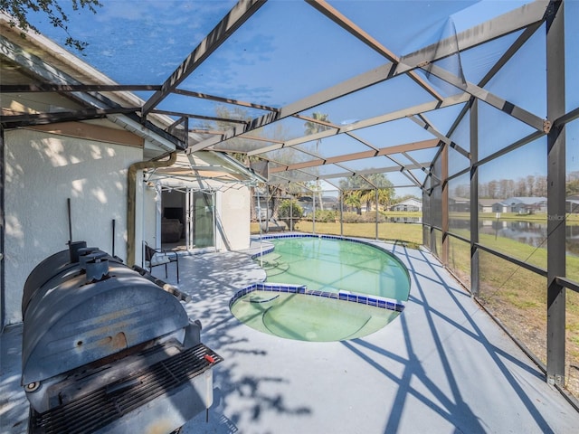 view of pool with a lanai, a patio area, a grill, and a pool with connected hot tub