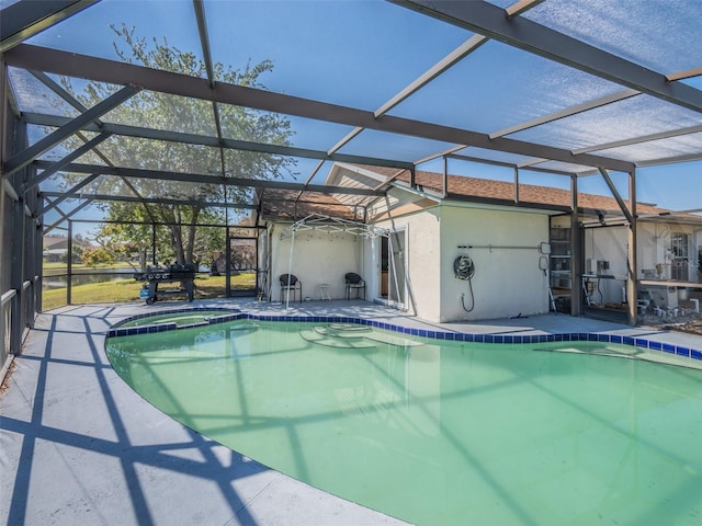 view of pool featuring a patio area, a lanai, and a pool with connected hot tub