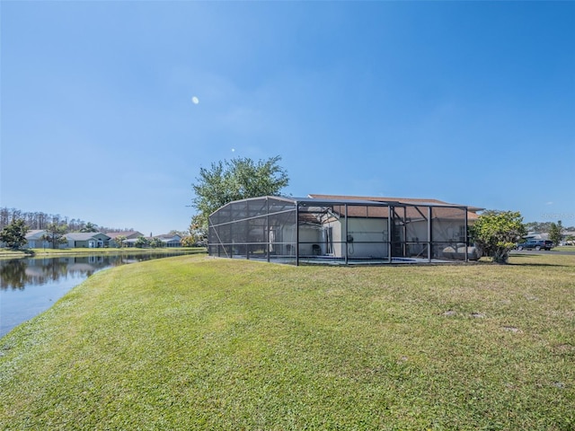 view of yard with a water view and a lanai