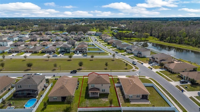 drone / aerial view featuring a water view and a residential view