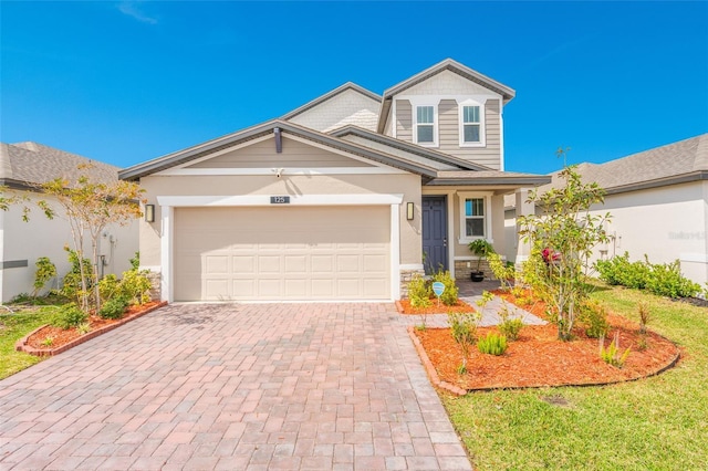 traditional-style home with a garage and decorative driveway