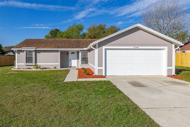 single story home with an attached garage, fence, concrete driveway, roof with shingles, and a front yard