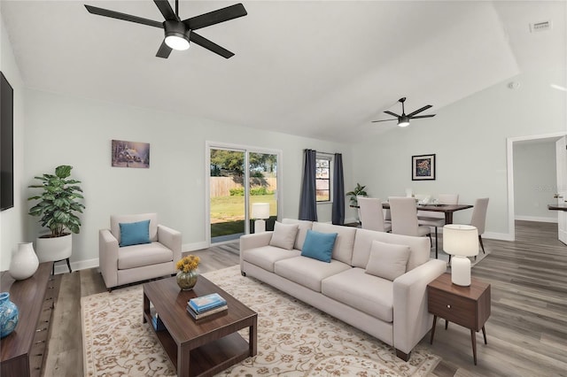 living area with light wood finished floors, visible vents, and a ceiling fan