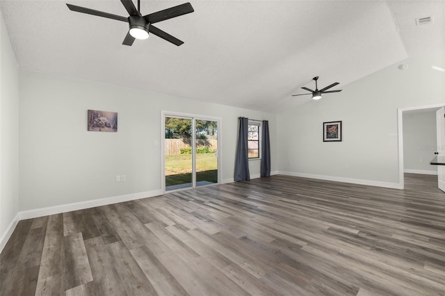 unfurnished living room featuring lofted ceiling, visible vents, a ceiling fan, wood finished floors, and baseboards