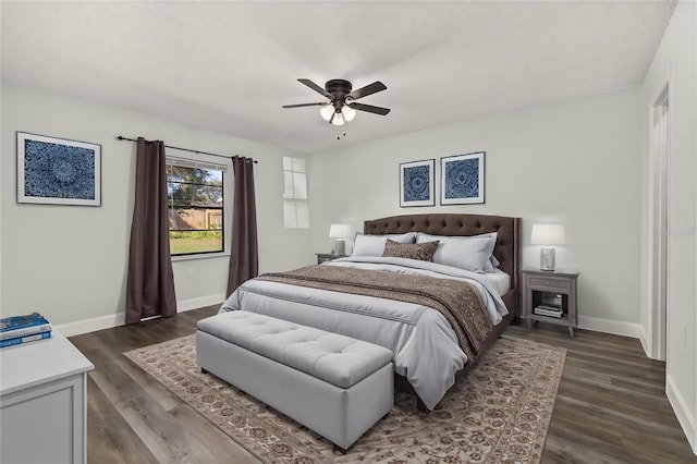 bedroom featuring dark wood-style floors, a ceiling fan, and baseboards