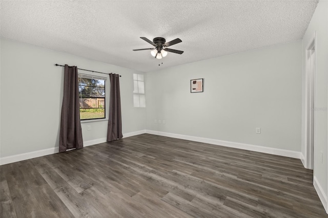 unfurnished room featuring ceiling fan, dark wood-style flooring, a textured ceiling, and baseboards