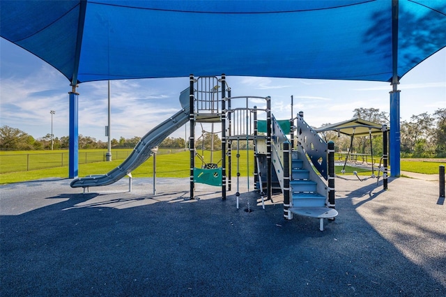 community jungle gym with a lawn