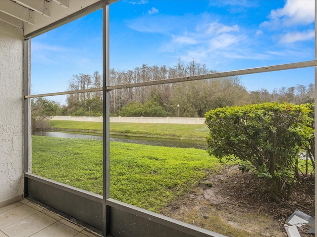 unfurnished sunroom with a healthy amount of sunlight and a water view