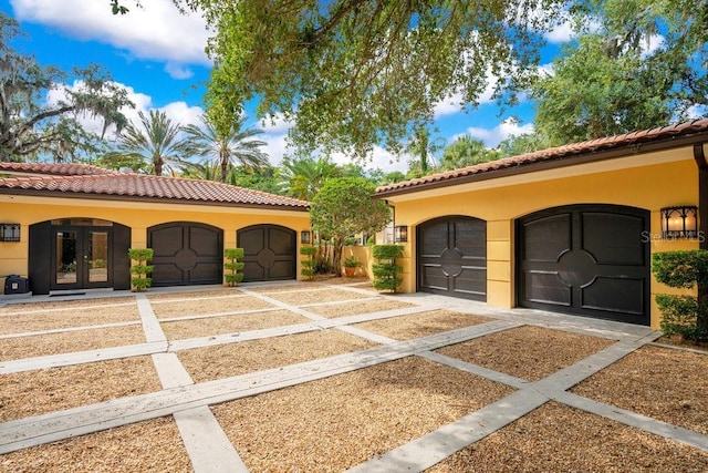 1400 Alabama Dr, Winter Park, FL 32789 - view of front of house with a tiled roof, french doors, and stucco siding