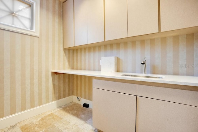 1400 Alabama Dr, Winter Park, FL 32789 - laundry area with baseboards, a sink, and cabinet space