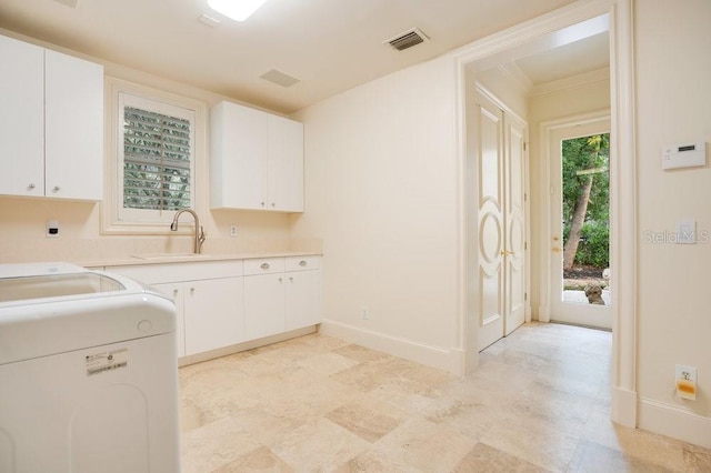1400 Alabama Dr, Winter Park, FL 32789 - laundry room with visible vents, a sink, washer and dryer, baseboards, and cabinet space