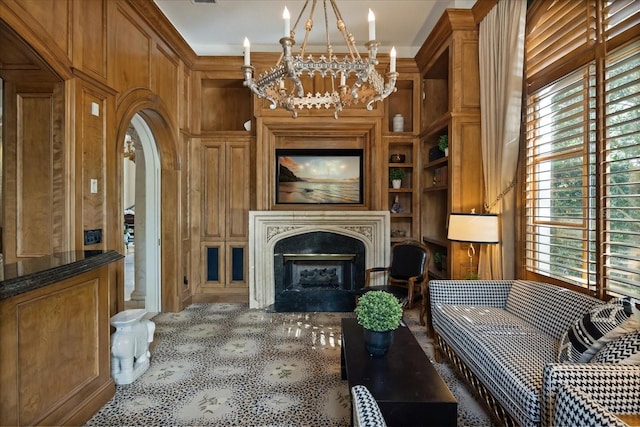 1400 Alabama Dr, Winter Park, FL 32789 - living room featuring built in shelves, arched walkways, an inviting chandelier, and a fireplace