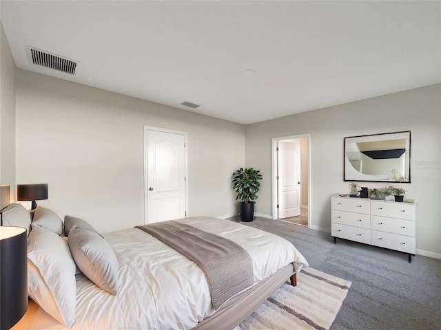 carpeted bedroom with visible vents and baseboards