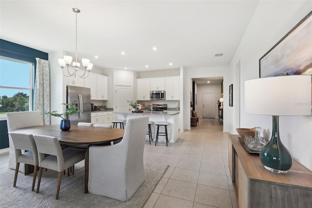 dining room featuring a chandelier, recessed lighting, and light tile patterned floors