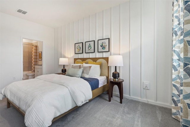 bedroom featuring ensuite bath, carpet, and visible vents