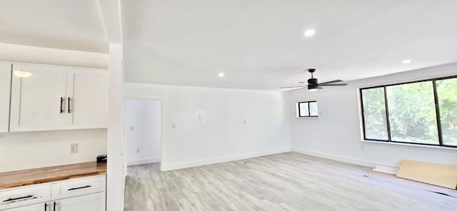 spare room featuring light wood-type flooring, ceiling fan, baseboards, and recessed lighting