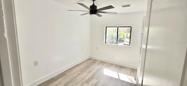 unfurnished room with light wood-style floors, baseboards, visible vents, and a ceiling fan