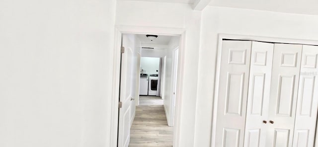 hall featuring light wood-style flooring and washing machine and clothes dryer