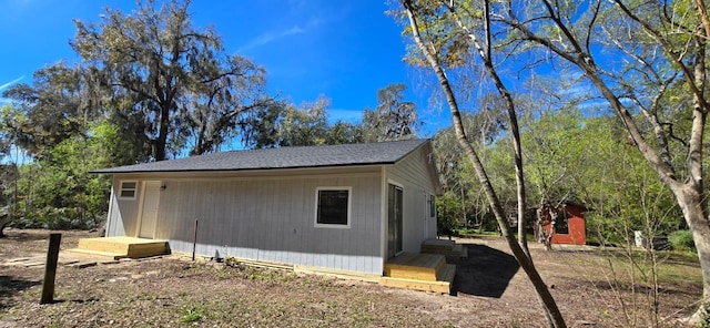 view of side of home featuring an outbuilding