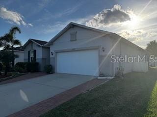 ranch-style home with a garage and driveway