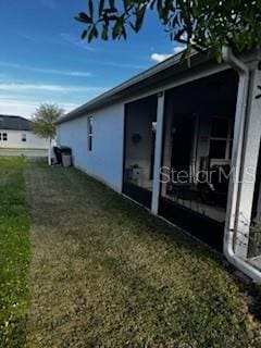 view of property exterior with a yard and stucco siding