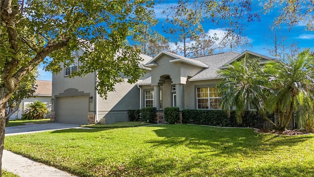 view of front facade featuring a garage, a shingled roof, concrete driveway, a front lawn, and stucco siding