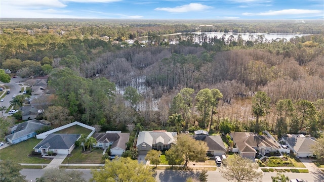 drone / aerial view with a residential view, a water view, and a forest view