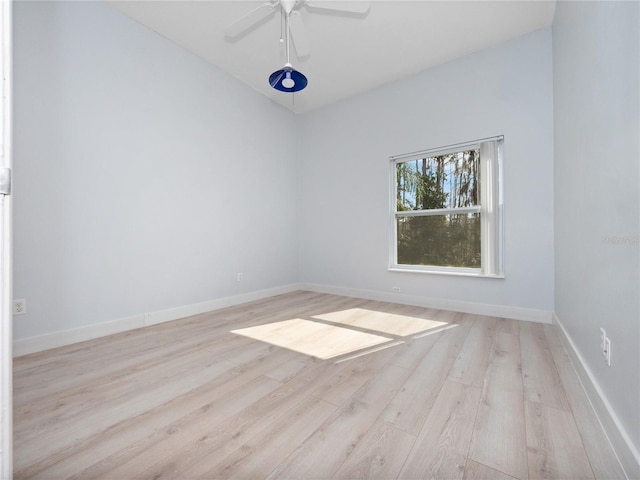 empty room with a ceiling fan, baseboards, and wood finished floors