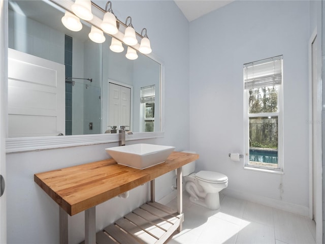 bathroom with vanity, tile patterned flooring, toilet, and an inviting chandelier