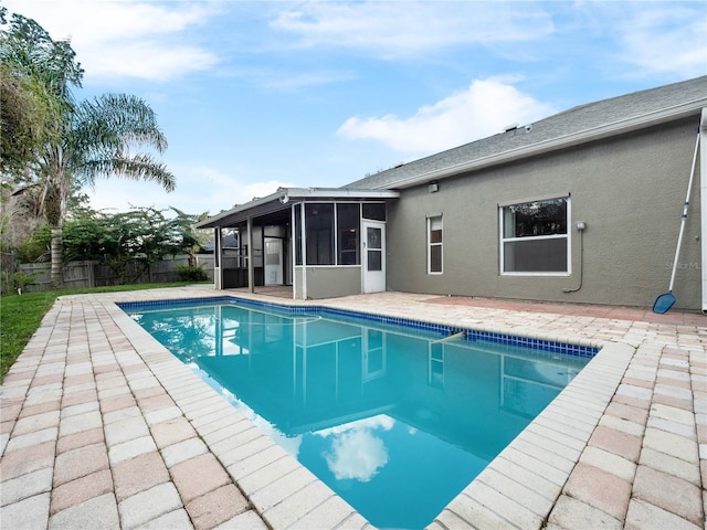 view of pool with a sunroom, a patio area, fence, and a fenced in pool