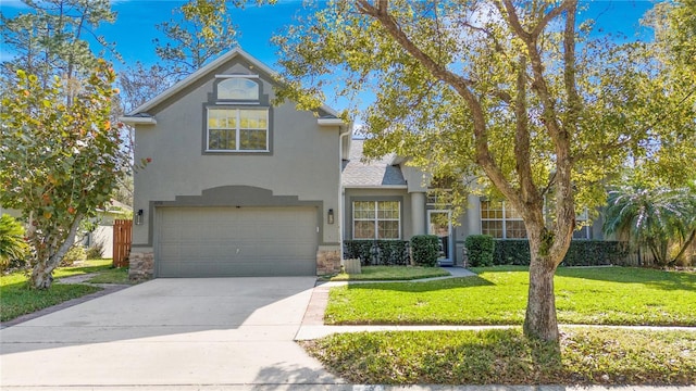 traditional-style house with a garage, concrete driveway, stone siding, stucco siding, and a front lawn