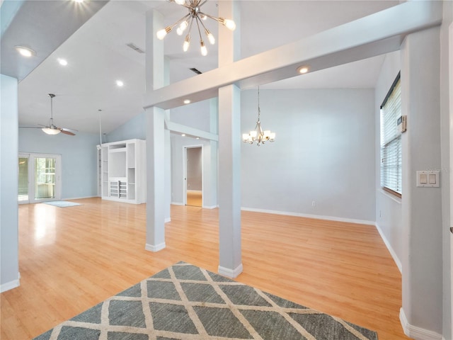 unfurnished living room with high vaulted ceiling, visible vents, baseboards, and wood finished floors